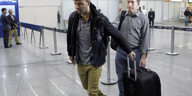 David Miranda (L), partner of Glenn Greenwald, is seen at Rio de Janeiro's Tom Jobim international airport on August 19, 2013.