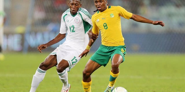 Nigeria's Namdi Ouduamadi challenges Siphiwe Tsabalala of South Africa in a friendly in Durban last month. Major rivals South Africa and Nigeria were drawn together on Wednesday in the first round of the 2014 African Nations Championship (CHAN).