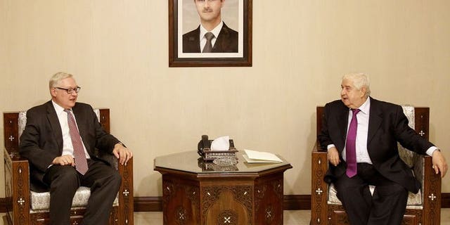 Syrian Foreign Minister Walid Muallem (R) meets with Russian Deputy Foreign Minister Sergei Ryabkov (L) in Damascus on September 17, 2013.