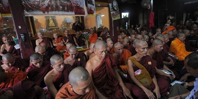 Myanmar Buddhist monks pray during a gathering to mark the sixth anniversary of "Saffron Revolution" at a monastery in Yangon on September 18, 2013.