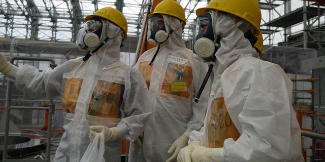 Workers inspect the Fukushima Dai-ichi nuclear power plant on September 12, 2013, in a photo taken by Tokyo Electric Power Co (TEPCO). Japanese Prime Minister Shinzo Abe Thursday ordered the operator of the crippled Fukushima nuclear plant to work out a schedule for stemming radioactive water leaks as he toured the facility.