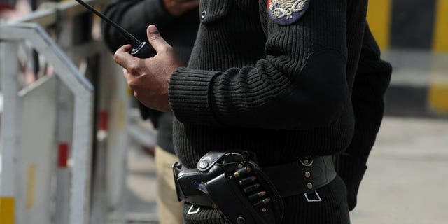 Pakistani police patrol on a street in Lahore on February 2, 2012. Pakistani police have arrested eight people after three men accused of serious crimes were made to walk over hot coals in a 'trial by fire' ritual to prove their innocence.