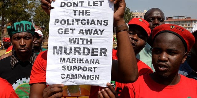 Minners march on South African government buildings in Pretoria on September 12, 2013. A South African commission of inquiry said Thursday that the police lied about the shooting dead of 34 striking miners last year, in a searing criticism of police conduct.