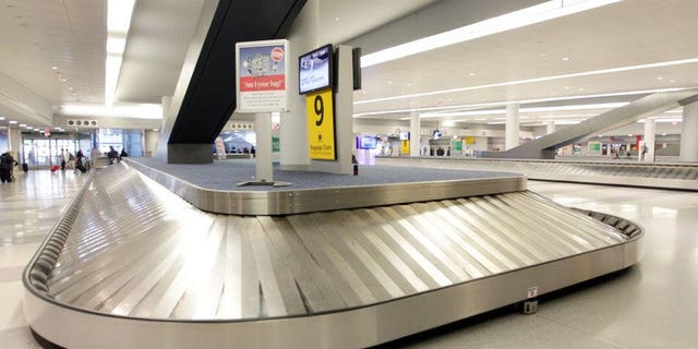 An empty baggage return area at New York's John F. Kennedy International Airport on October 31, 2012. A five-month-old baby died in a Spanish airport on Thursday after being placed on a luggage belt that then started moving without its parents noticing, officials said.
