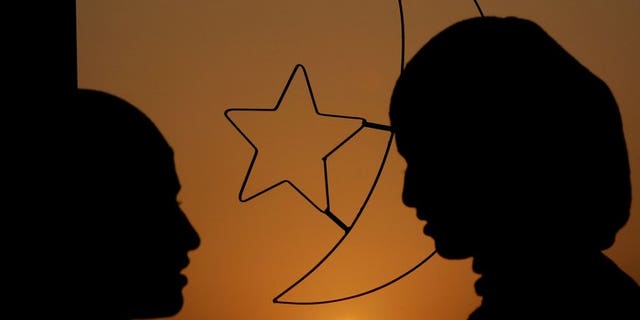 Women stand in front of a window decoration of Islam's crescent moon and a five point star. Tunisian women have travelled to Syria to wage "sex jihad" by comforting Islamist fighters battling the regime there, Interior Minister Lotfi ben Jeddou has told MPs.
