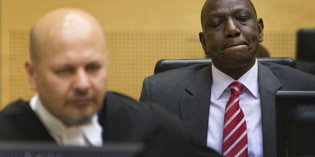 Kenya's Deputy President William Ruto (right) reacts as he sits in the courtroom before their trial at the International Criminal Court (ICC) in The Hague on September 10, 2013. African leaders are to hold a special summit next month amid growing opposition to the crimes against humanity trials of Kenya's leadership at the International Criminal Court.