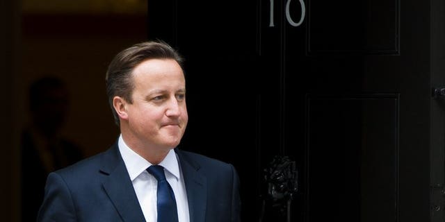 Prime Minister David Cameron, stands outside 10 Downing Street, central London on September 18, 2013. Facing the prospect of a family wedding just hours after a gruelling G20 summit, Cameron grabbed forty winks on a bed -- unaware that his sister-in-law was posing for the camera in front of him.