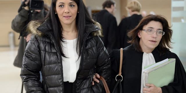 Bouchra Bagour (L), the mother of a boy named Jihad who was born on September 11, leaves Avignon's courthouse in southern France on December 19, 2012, with her lawyer Gaelle Genoun, after her trial for sending her son to school in a T-shirt with "I am a bomb" written on it.