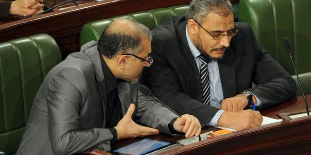 Tunisia's Islamist Prime Minister Ali Larayedh (L) chats with leader of Ennahda's Parliamentary group, Sahbi Atig as they attend a constituent assembly meeting on September 19, 2013.
