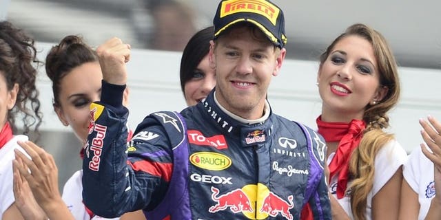 Red Bull Racing's German driver Sebastian Vettel celebrates on the podium at the Autodromo Nazionale circuit in Monza on September 8, 2013 after the Italian Formula One Grand Prix. Vettel has been fined 200 euros ($270) for speeding in the pitlane at the Singapore Grand Prix -- an amount he earns in less than 10 minutes.
