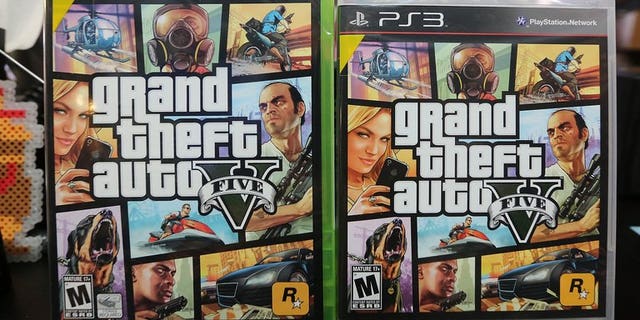 Copies of Grand Theft Auto V displayed at the 8 Bit & Up video game shop in Manhattan's East Village on September 18, 2013 in New York. Three British teenagers have been charged over the stabbing and robbery of a man who was walking home after buying the blockbuster videogame, police said on Saturday.