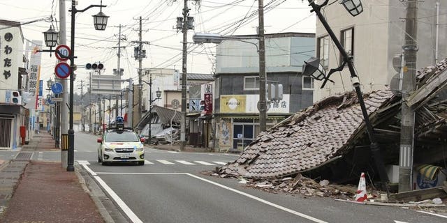 A Google car mounted with a street view camera drives through a street in Namie, on March 28, 2013. namie -- a town abandoned after the Fukushima nuclear accident -- has protested Prime Minister Shinzo Abe's global promise that the situation of the crippled plant was "under control".