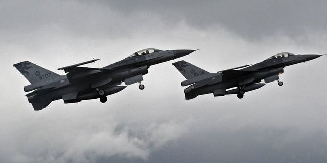 Two F-16 fighters take-off from the Hualien air force base in eastern Taiwan, on January 23, 2013. Taiwan's air force will be armed with "smart" munitions before the year's end that could be used against any Chinese invasion by striking airfields and harbours on the mainland, according to a report in the China Times.