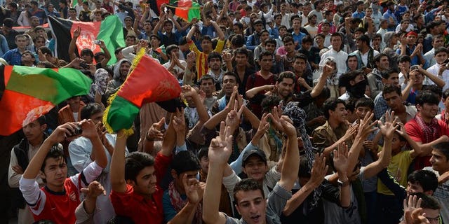 Afghans celebrate their national football team's victory in the South Asian Football Federation Championship, at the Kabul stadium on September 12, 2013. UEFA president Michel Platini is set to visit Afghanistan on Sunday to lend his support to football in the war-torn country, weeks after it claimed its first international trophy.
