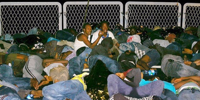 Mainly Syrian refugees rest aboard a boat after being rescued overnight by the Italian Navy near the Italian port of Pozzallo, south of Sicily on September 16, 2013.