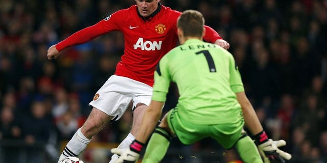 Manchester United's Wayne Rooney (left) and Bayer Leverkusen's Bernd Leno at Old Trafford, September 17, 2013. Rooney was never close to joining Chelsea in the summer because Manchester United would not have sold him, former chief executive David Gill said Sunday.