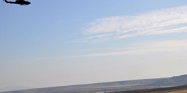 A Turkish helicopter flies near the Turkish-Syrian border village of Katran, on November 28, 2011. Turkey's air force has paid tribute to the crew who shot down a Syrian military helicopter which it said had violated Turkish airspace.