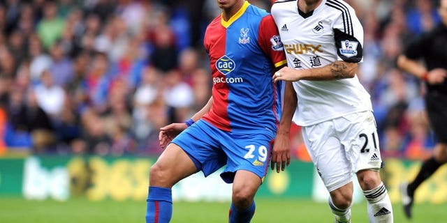 Crystal Palace's Marouane Chamakh and Swansea City's Jose Alberto Canas at Selhurst Park in south London on September 22, 2013. Swansea carried on from where they left off in Europe with a 2-0 Premier League win away to strugglers Crystal Palace on Sunday.