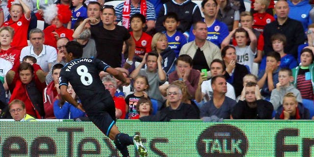 Tottenham Hotspur's Brazilian midfielder Paulinho celebrates scoring his team's opening goal during the English Premier League football match between Cardiff City and Tottenham Hotspur at The Cardiff City Stadium in Cardiff on September 22, 2013. Tottenham won the match 1-0.