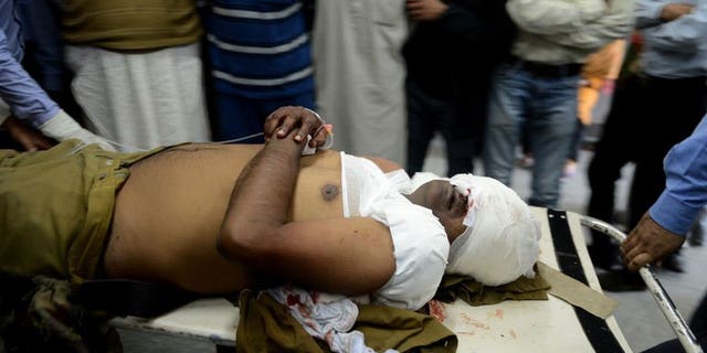 An injured Indian Central Industrial Security Force (CISF) soldier is carried through a hospital in Srinagar on September 23 ,2013. Suspected militants shot and killed a paramilitary soldier and critically wounded another on Monday in a busy market in Indian Kashmir's main city of Srinagar, police said.