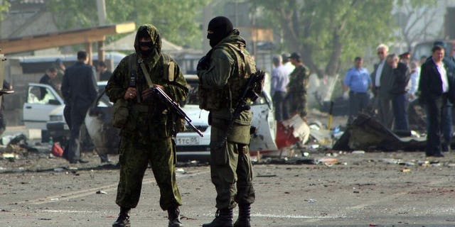 File picture shows special forces officers guarding the site of two blasts in the Dagestan's capital Makhachkala early on May 4, 2012.