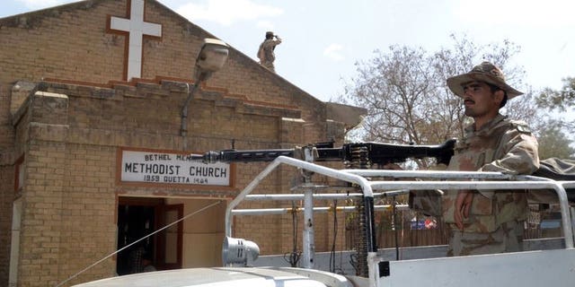 Pakistani soldiers stand guard outside a church in Quetta in Pakistan's restive southwest on September 22, 2013, following two suicide bomb attacks on a church in Peshawar. A bomb targeting police and claimed by the Taliban killed at least five people and wounded five others near Quetta on Monday, police said.