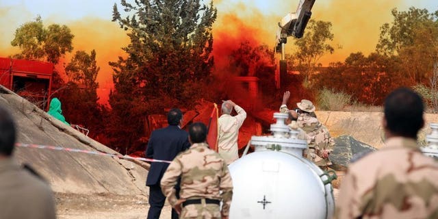 A team of Libyan experts and military engineers monitor a dump tank, under the supervision of the United Nations, in Tripoli on November 11, 2012. Experts were assigned to dump the toxic chemicals found in the air defense missiles and ammunition that was left over from the former Libyan leader Moamer Kadhafi's regime.