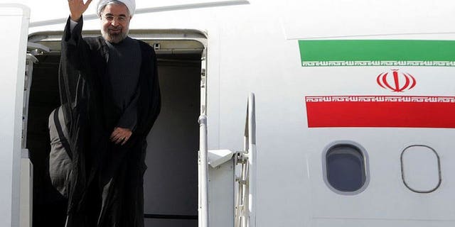 A handout picture released by the Iranian presidency shows President Hassan Rowhani waving before entering an airplane to attend the UN General Assembly, at Tehran's Mehrabad Airport on September 23, 2013.