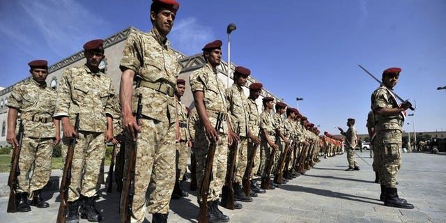 Yemeni soldiers parade during the funeral of victims of bombing attacks on the Gulf of Aden on September 22, 2013 in Sanaa. Unidentified gunmen shot dead on Tuesday a Yemeni air force officer in the capital, the second killing of its kind in less than 24 hours, a military official said.