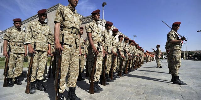 Yemeni soldiers parade during the funeral of victims of bombing attacks on the Gulf of Aden on September 22, 2013 in Sanaa. Unidentified gunmen shot dead on Tuesday a Yemeni air force officer in the capital, the second killing of its kind in less than 24 hours, a military official said.