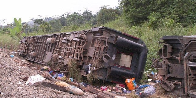 An overturned carriages lie near the rail track in Yanga, Congo-Brazzaville, on June 22,2010. A rail crash killed three people and injured 28 others in the Republic of Congo, when a passenger train hit one laden with oil tankers, a transport official said Tuesday.