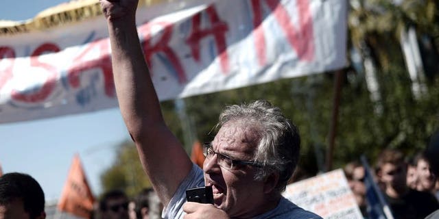 A Greek demonstrator shouts slogans during a rally in Athens, on September 24, 2013. Thousands of Greek civil servants have protested at the start of a fresh strike against job cuts pushed by the government in return for international bailout loans.
