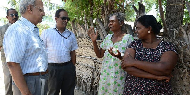 Foreign observers speak with Sri Lankan Tamil residents at The Kanniamman Welfare Centre at the country's northern most tip of Point Pedro on September 19, 2013.