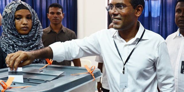 Maldivian presidential candidate Mohamed Nasheed smiles as he casts his vote at a local polling station in Male on September 7, 2013.