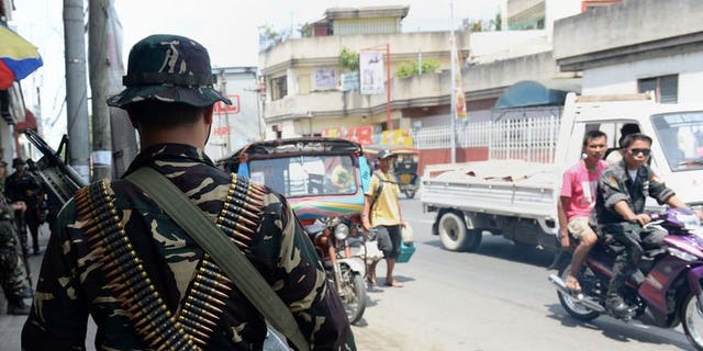 Philippine soldiers patrol the streets as government forces clash anew with remnants of Muslim rebels in Zamboanga City, on southern island of Mindanao on September 21, 2013.