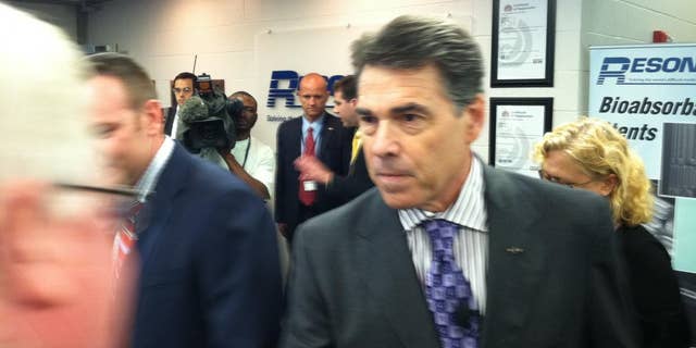 Rick Perry greets participants at an economic roundtable in Nashua, NH on Wednesday