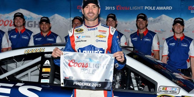 Nov 13, 2015; Avondale, AZ, USA; NASCAR Sprint Cup Series driver Jimmie Johnson poses for a picture after winning the pole for the Quicken Loans Race For Heroes 500 at Phoenix International Raceway. Mandatory Credit: Jasen Vinlove-USA TODAY Sports
