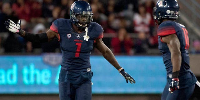 Nov 14, 2015; Tucson, AZ, USA; Arizona Wildcats safety Tellas Jones (1) and safety Will Parks (11) celebrate after a fumble recovery during the fourth quarter against the Utah Utes at Arizona Stadium. Arizona won 37-30 in double overtime. Mandatory Credit: Casey Sapio-USA TODAY Sports