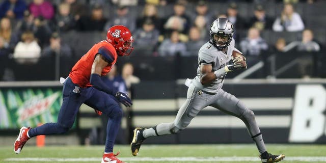 Oct 17, 2015; Boulder, CO, USA; Colorado Buffaloes wide receiver Bryce Bobo (4) runs with the ball after catching a pass under pressure from Arizona Wildcats safety Jamar Allah (7) during the second half at Folsom Field. Arizona won 38-31. Mandatory Credit: Chris Humphreys-USA TODAY Sports
