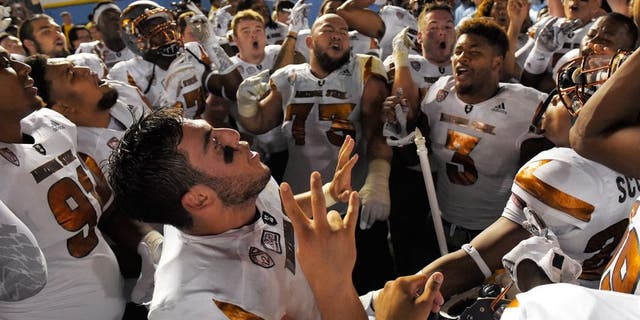 Arizona State quarterback Mike Bercovici, below, celebrates with teammate after they defeated UCLA in an NCAA college football game, Saturday, Oct. 3, 2015, in Pasadena, Calif. Arizona State won 38-23. (AP Photo/Mark J. Terrill)