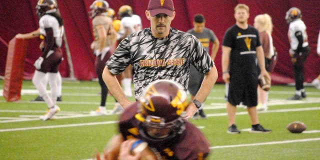 ASU offensive coordinator Mike Norvell watches the running backs in ball protection drill inside the Verde Dickey Dome on October 6, 2015 in Tempe.
