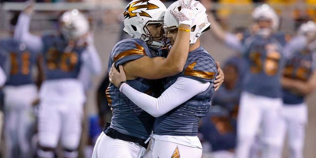 Arizona State's Zane Gonzalez, right, gets a hug from holder Matt Haack after Gonzalez connected for a field goal during the second half of an NCAA college football game against UCLA on Saturday, Oct. 8, 2016, in Tempe, Ariz. Gonzalez kicked three field goals to become the NCAA's all-time leader with 89. Arizona State defeated UCLA 23-20. (AP Photo/Ross D. Franklin)