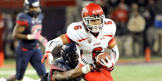 Oct 19, 2013; Tucson, AZ, USA; Utah Utes wide receiver Dres Anderson (6) is tackled by Arizona Wildcats linebacker Marquis Flowers (2) during the fourth quarter at Arizona Stadium. Arizona beat Utah 35-44. Mandatory Credit: Casey Sapio-USA TODAY Sports