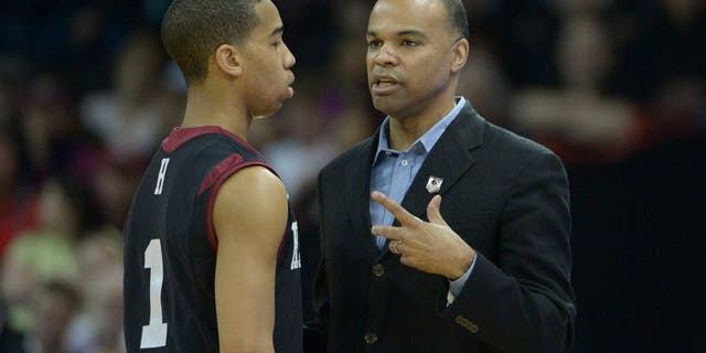 Mar 20, 2014; Spokane, WA, USA; Harvard Crimson head coach Tommy Amaker (right) instructs guard Siyani Chambers (1) against the Cincinnati Bearcats in the first half of a men's college basketball game during the second round of the 2014 NCAA Tournament at Veterans Memorial Arena. Mandatory Credit: Kirby Lee-USA TODAY Sports
