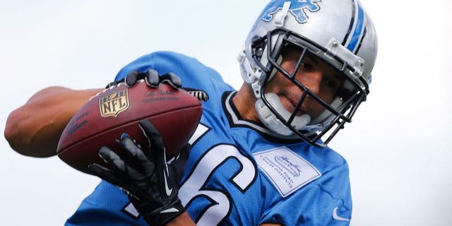 Detroit Lions wide receiver Lance Moore catches a pass during NFL football training camp in Allen Park, Mich., Monday, Aug. 3, 2015. (AP Photo/Paul Sancya)