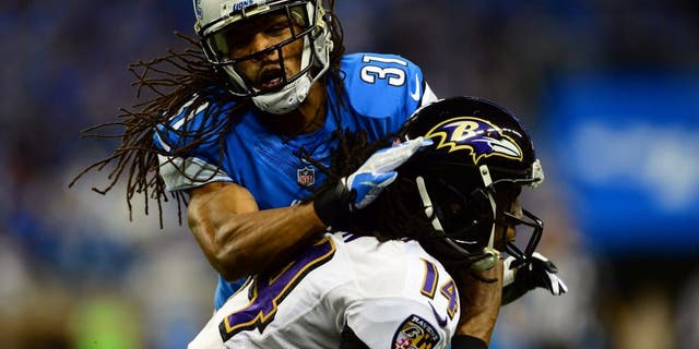 Dec 16, 2013; Detroit, MI, USA; Detroit Lions cornerback Rashean Mathis (31) tackles by Baltimore Ravens wide receiver Marlon Brown (14) during the second quarter at Ford Field. Mandatory Credit: Andrew Weber-USA TODAY Sports