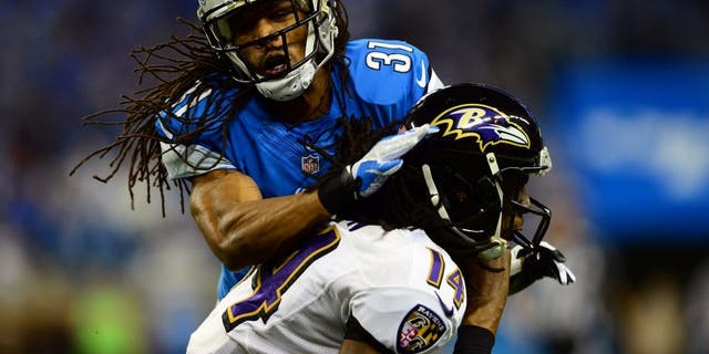 Dec 16, 2013; Detroit, MI, USA; Detroit Lions cornerback Rashean Mathis (31) tackles by Baltimore Ravens wide receiver Marlon Brown (14) during the second quarter at Ford Field. Mandatory Credit: Andrew Weber-USA TODAY Sports