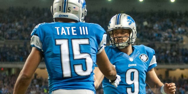 Dec 14, 2014; Detroit, MI, USA; Detroit Lions wide receiver Golden Tate (15) celebrates his touchdown with quarterback Matthew Stafford (9) during the second quarter against the Minnesota Vikings at Ford Field. Mandatory Credit: Tim Fuller-USA TODAY Sports