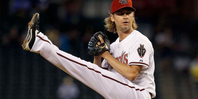 Arizona Diamondbacks' Bronson Arroyo winds up to throw a pitch against the Houston Astros during the first inning of a baseball game on Tuesday, June 10, 2014, in Phoenix. (AP Photo/Ross D. Franklin)