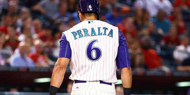 Aug 27, 2015; Phoenix, AZ, USA; Arizona Diamondbacks outfielder David Peralta carries his broken bat to the dugout after striking out and breaking it against the St. Louis Cardinals at Chase Field. Mandatory Credit: Mark J. Rebilas-USA TODAY Sports